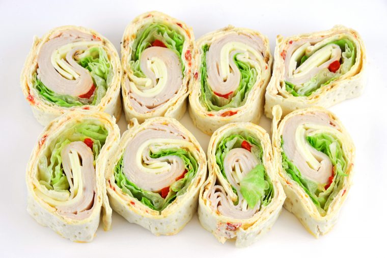 tortilla deli wrap rolls with turkey vegetable isolated on white background