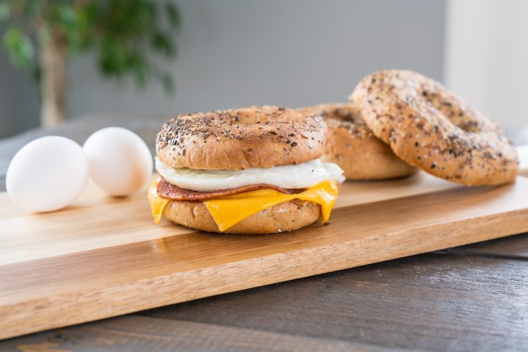 ham, egg and cheese on a bagel sandwich featuring fischer's ham