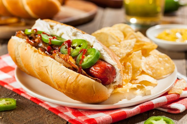 seattle style hot dog with cream cheese, jalapeños, Sriracha and grilled onions