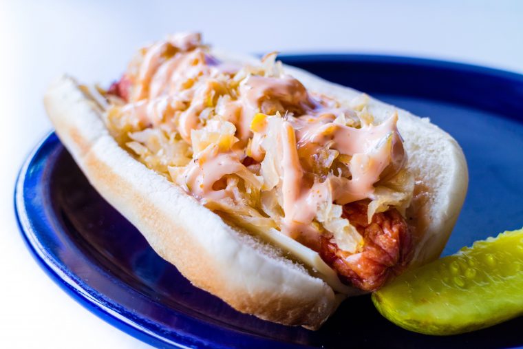 kansas city style hot dog like a reuben sandwich with sauerkraut, thousand island dressing and melted swiss cheese